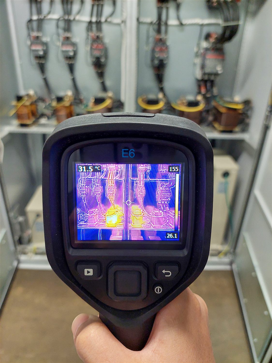 FLIR thermal camera showing a live thermal image of switchgear during an AMKA survey